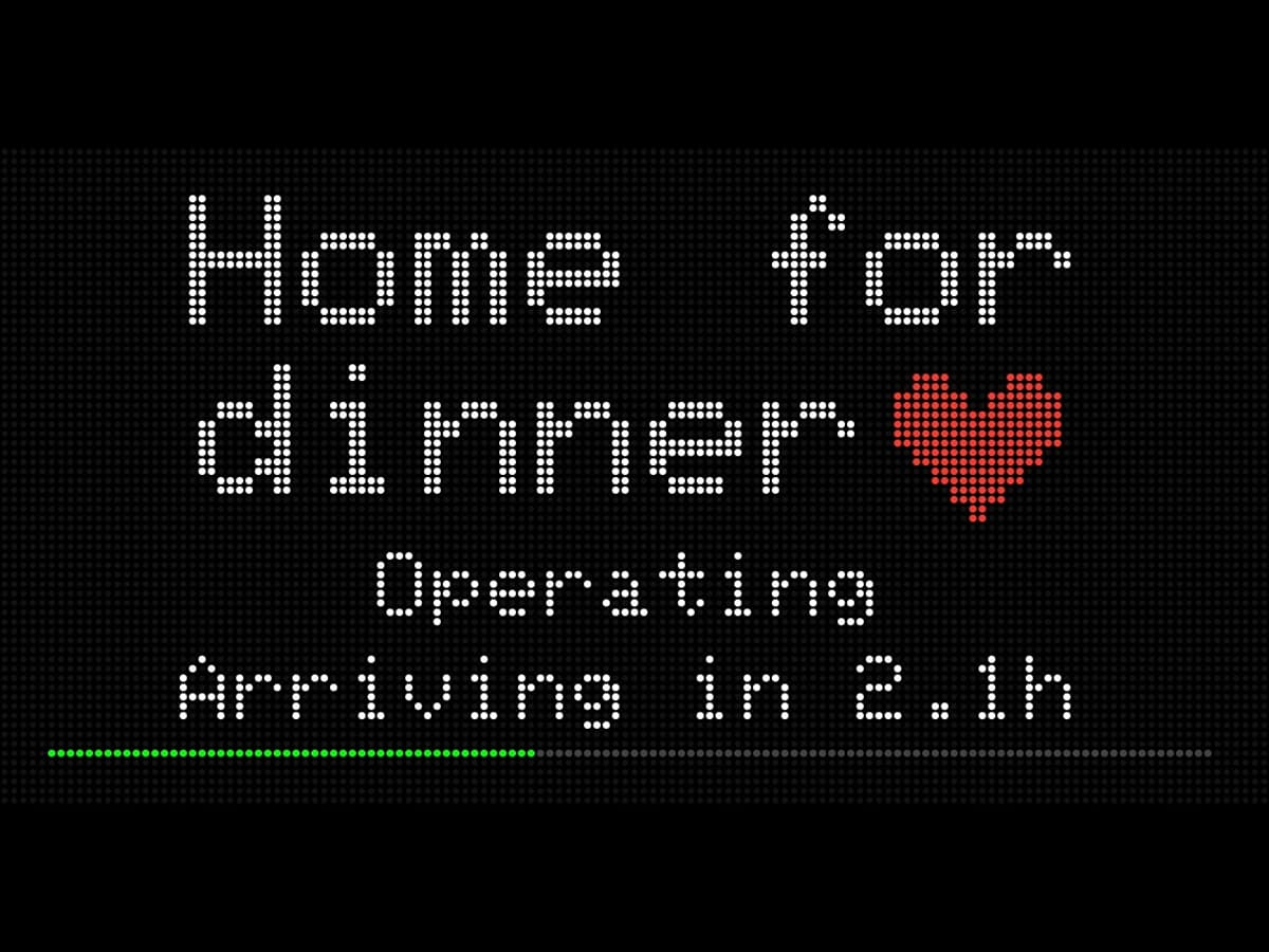 A FlightWall reading Home for dinner with a red heart, above the leg status and arrival time